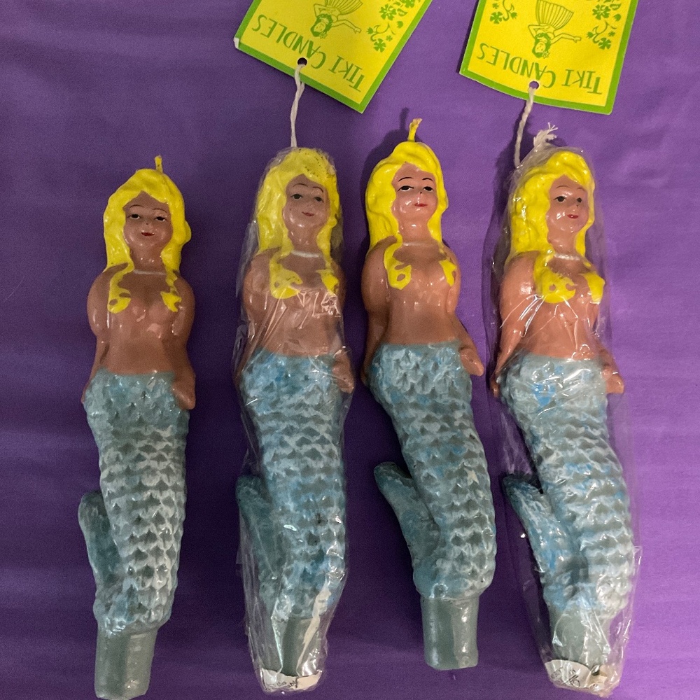 4 mermaid candles and two candle holders. H139